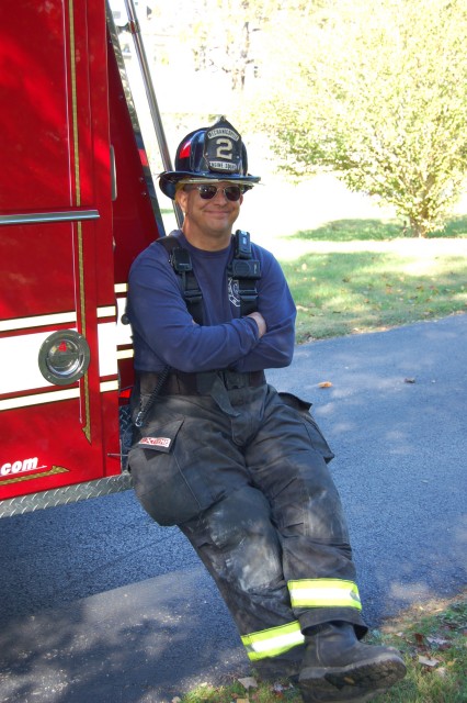 Firefighter/EMT Bob Renfrew resting on Engine 21 